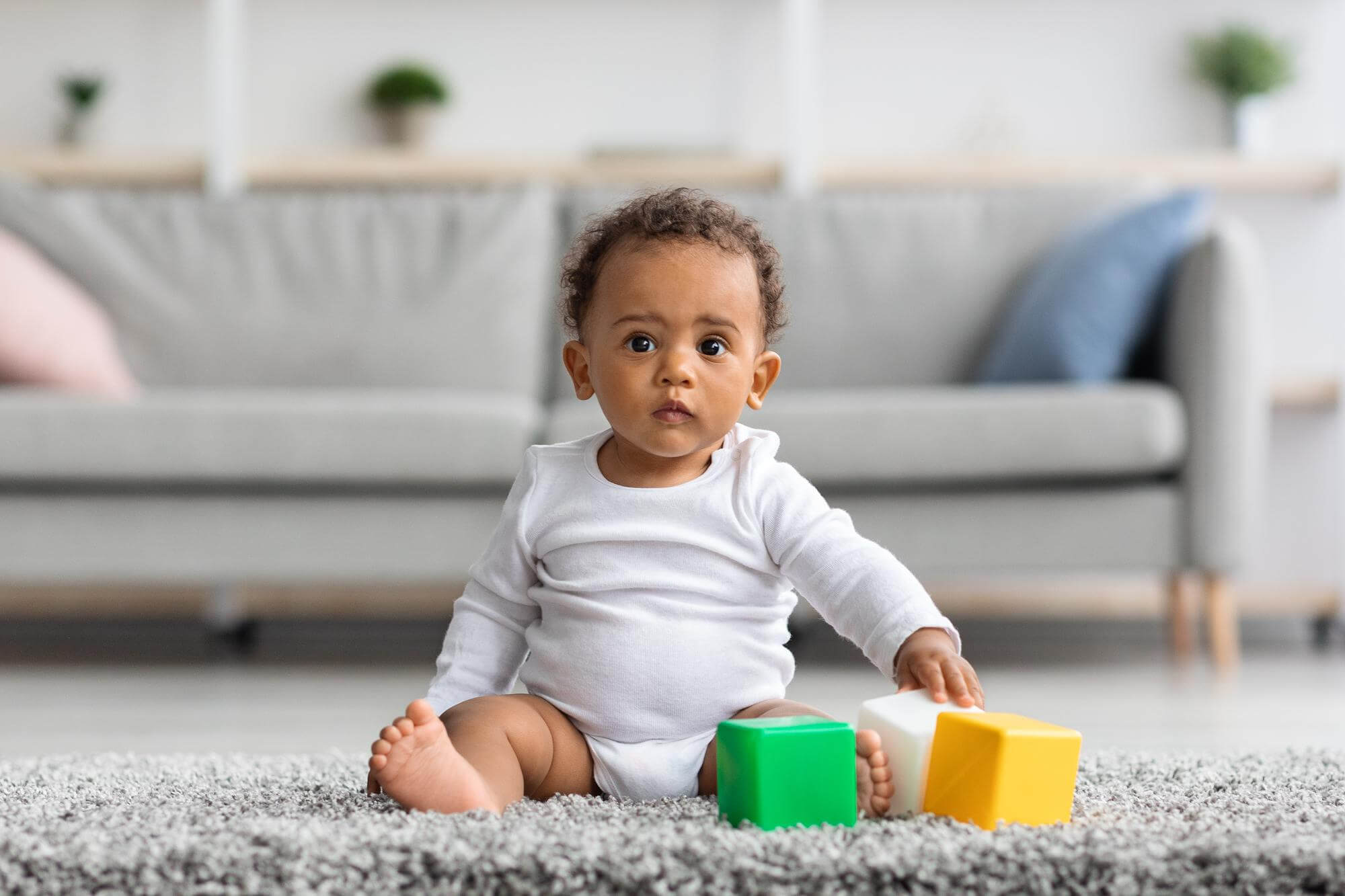 bebe sentado con juguetes